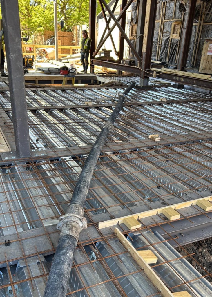 A King Concrete Pumping line pump feeding concrete on site near Redhill